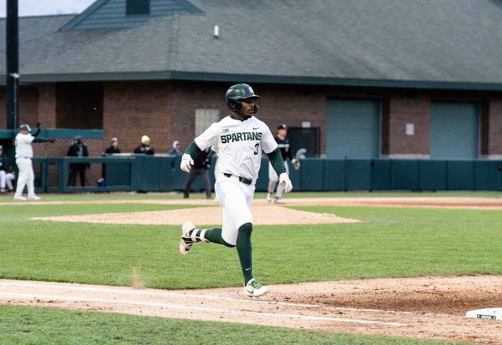 <p>Junior Zaid Walker sprints to first base during the Oakland matchup on April 19, 2022. </p>