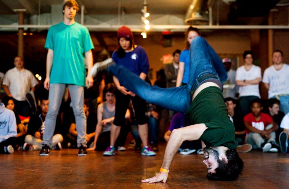 MSU Breakdance Club treasurer chemistry senior Dylan Denison spins atop his head Saturday afternoon during Red Cedar Ransom held at The Loft. Dance crews of all ages battled it out for the chance to win $1500. Matt Hallowell/The State News