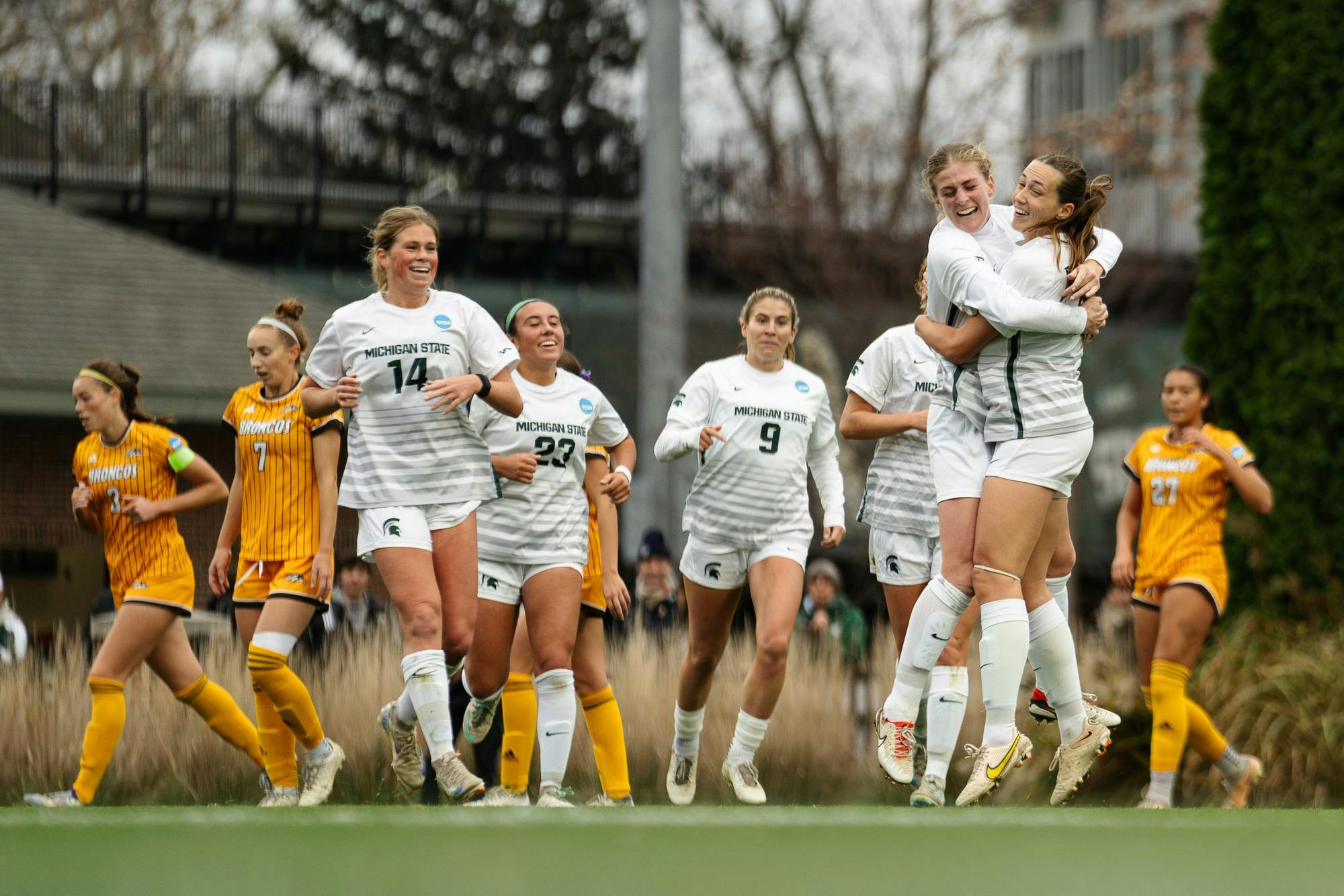 Michigan State graduate student midfielder Justina Gaynor (18) celebrates with teammates after scoring the second goal of the game against Western Michigan at DeMartin Stadium on Nov. 16, 2024. This matchup was the first round of the NCAA D1 women’s soccer tournament, with the Spartans defeating the Broncos 3-1. 