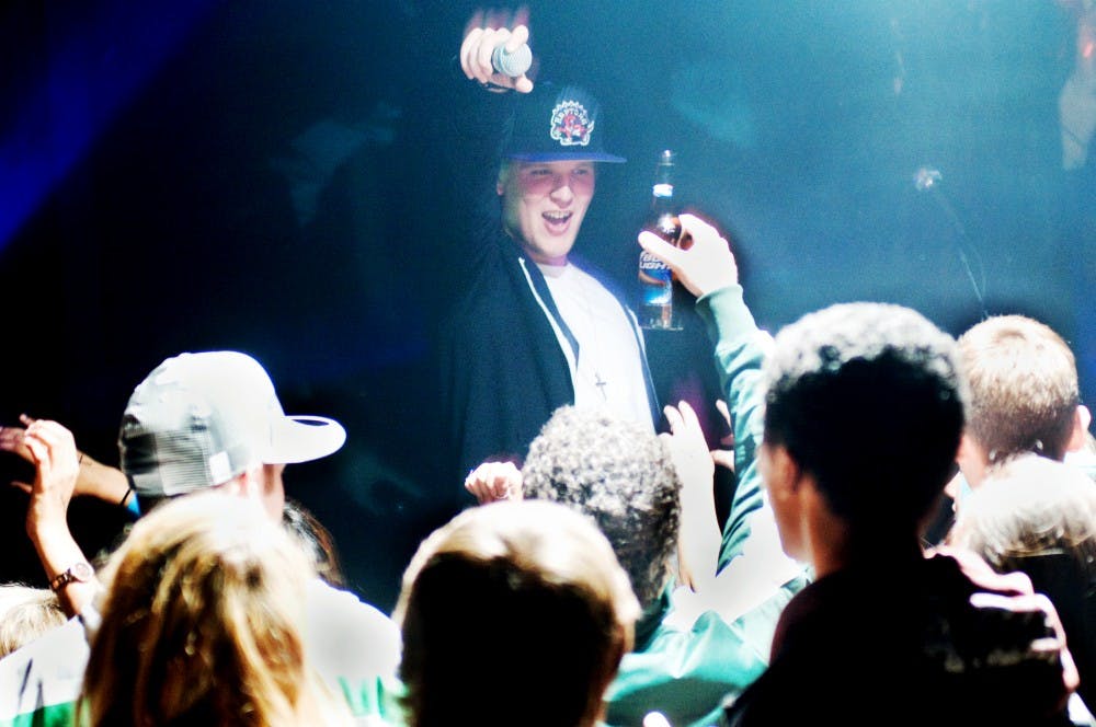 Patrick Duda of The Specktators interacts with the crowd Friday night at Mac's Bar, 2700 E. Michigan Ave., Lansing. The Specktators, a rap hip-hop/electronic group consisting of brothers Matt Duda (known as Moe-T) and Patrick Duda (known as Packi) performed one of their popular songs, "EL Girls." Jaclyn McNeal/The State News