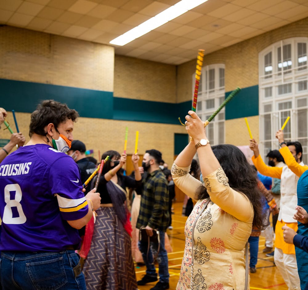 <p>People participating in Dandiya Raas, an Indian folk dance, at the Diwali celebration that was held at IM West Circle on MSU’s campus on Nov. 5, 2021. The event was put on by the Indian Student Organization at MSU in collaboration with the International Students’ Organization.</p>