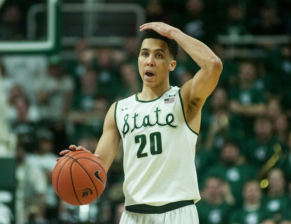 <p>Senior guard Travis Trice signals to his teammates Feb. 14, 2015, during the game against Ohio State at Breslin Center. The Spartans defeated the Buckeyes, 59-56. Erin Hampton/The State News</p>