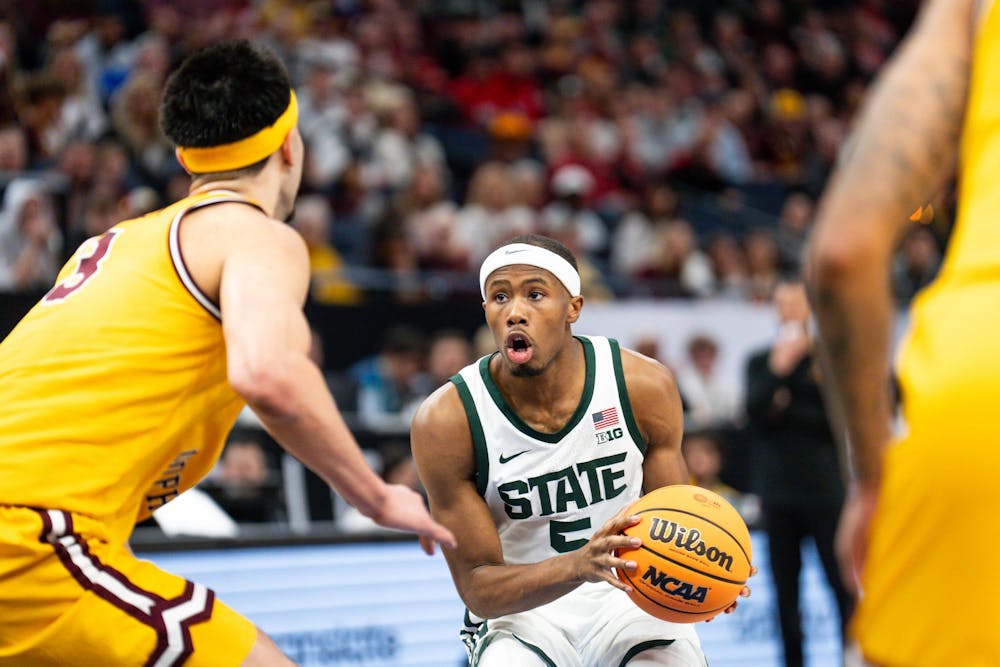 Michigan State sophomore guard No. 5 Tre Holloman ldrives the net against the University of Minnesota during the Big Ten Tournament in Minneapolis, March 14, 2024. The Spartans knocked the Golden Gophers out of the tournament, securing a spot in the quarterfinals against No. 1 seed Perdue.
