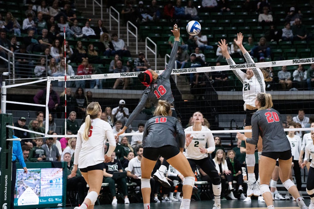<p>Senior outside hitter Jenaisya Moore (18), attempting to block the ball at the Ohio State v. MSU game held at the Breslin Center on November 5, 2022. The Spartans fell to the Buckeyes 3-0.</p>