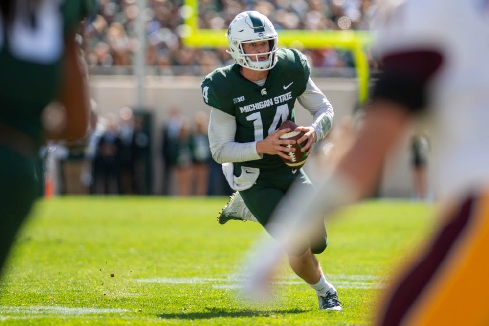 Junior quarterback Brian Lewerke (14) runs with the ball during the game against Central Michigan at Spartan Stadium on Sept. 29, 2018. The Spartans defeated the Chippewas 31-20.