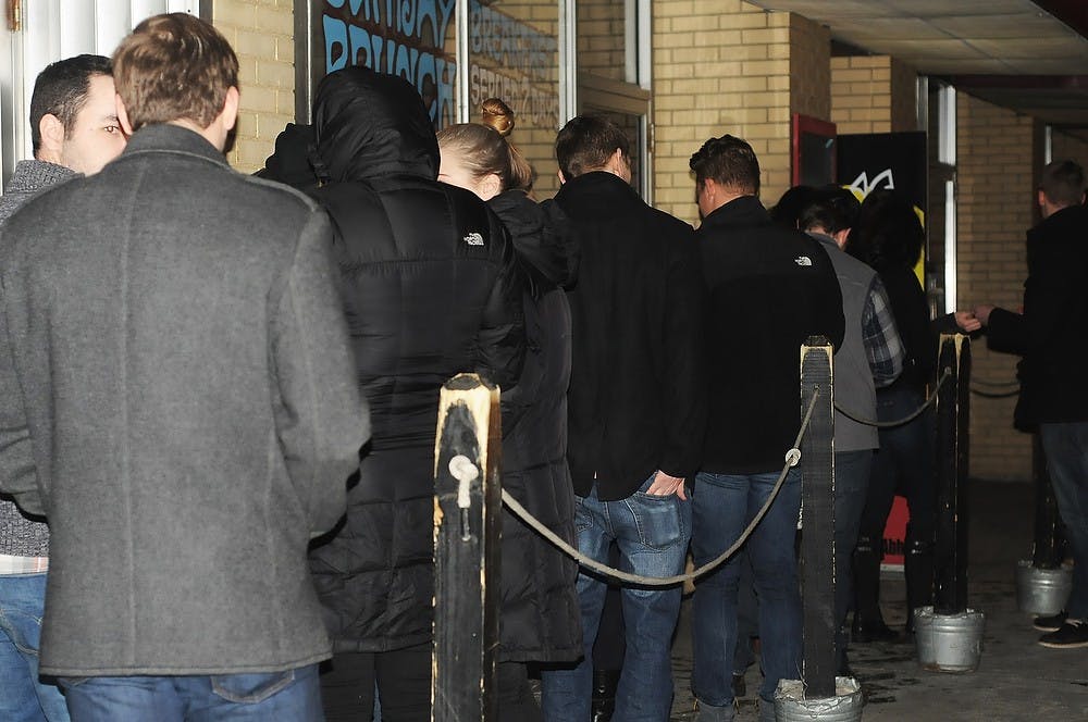 <p>Students brave the cold Jan 30, 2015, outside Rick's American Cafe 224 Abbot Rd East Lansing. Kennedy Thatch/The State News. </p>