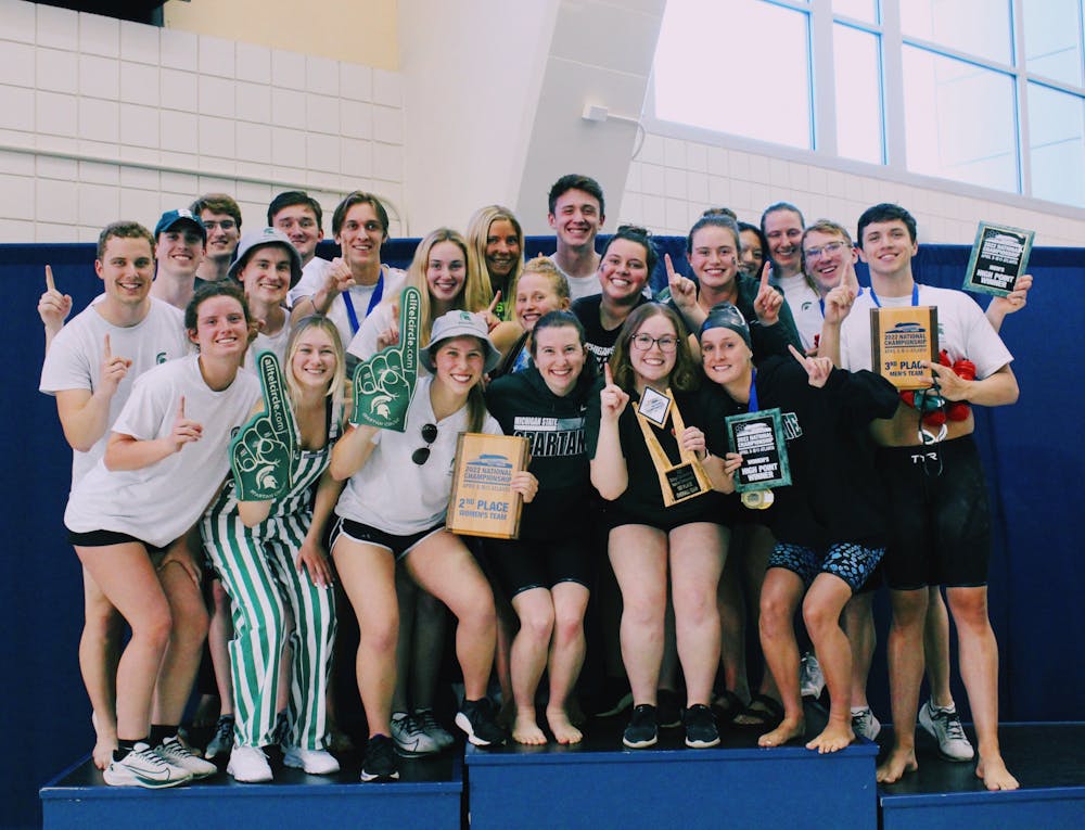 <p>The MSU Club Swimming and Diving Team celebrates with their national championship trophy in Atlanta, GA. - Courtesy of Kasey Venn</p>