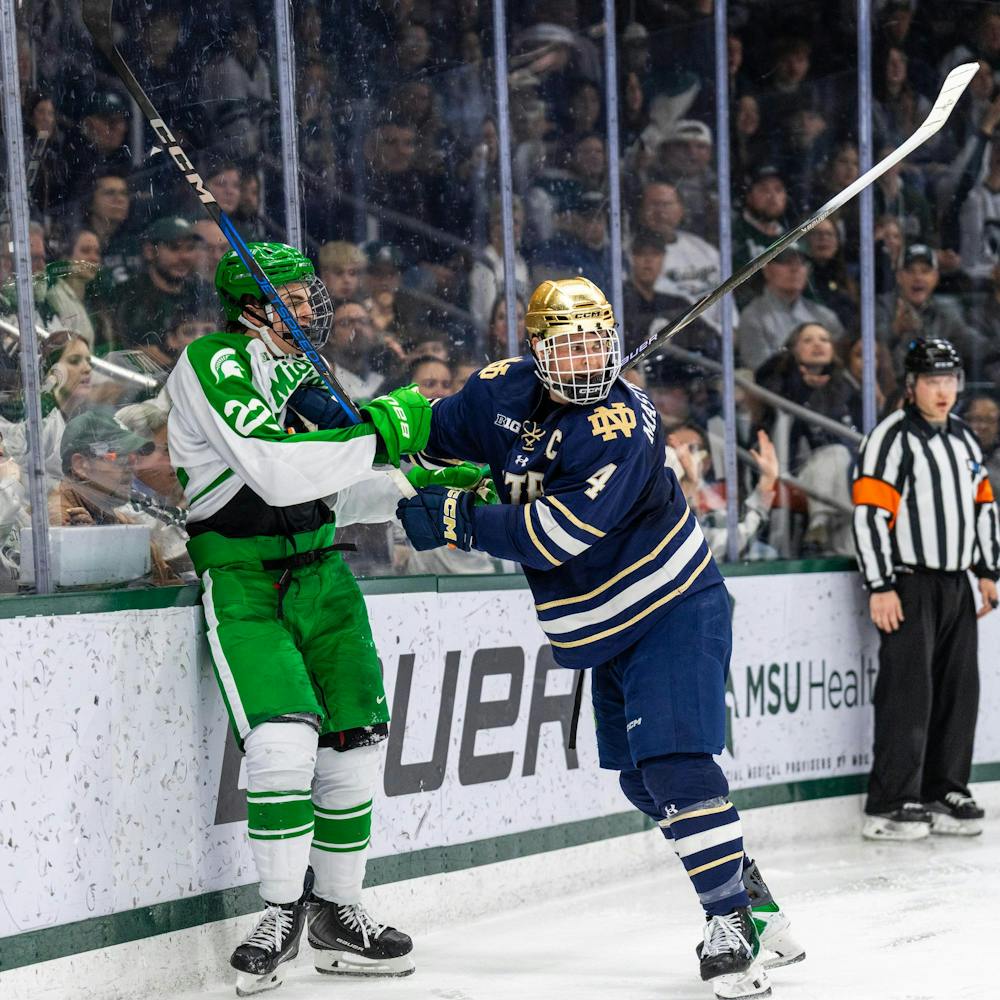 MSU Fr. F, Porter Martone (22), shoves a Notre Dame player after getting pushed into the wall in Munn Ice Arena in East Lansing, MI on Feb. 19, 2026.
