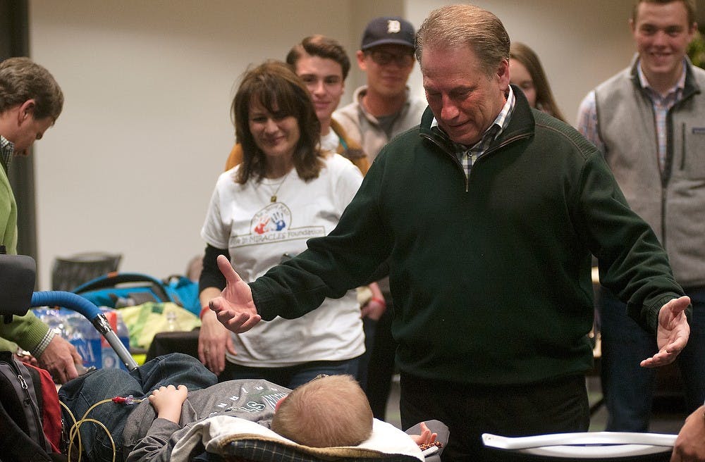 <p>Men's basketball head coach Tom Izzo meets 14 year old Isaac Postma April 22, 2015, at Breslin Center. Postma, of Grand Rapids, Michigan is living with Spinal Muscular Atrophy. Michigan State's Delta Sigma Phi fraternity raised money in conjunction with Janna Kast Believe In Miracles Foundation to send Isaac to Disney World this summer. Kennedy Thatch/The State News</p>