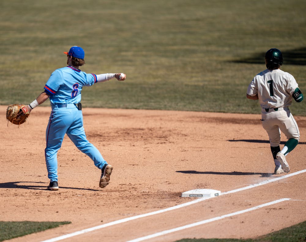 You're out! Houston Baptist senior Jake Miller catches the ball as sophmore Trent Farquhar runs past first base. MSU would later win the first game on March 20, 2022 1-0 against Houston Baptist.