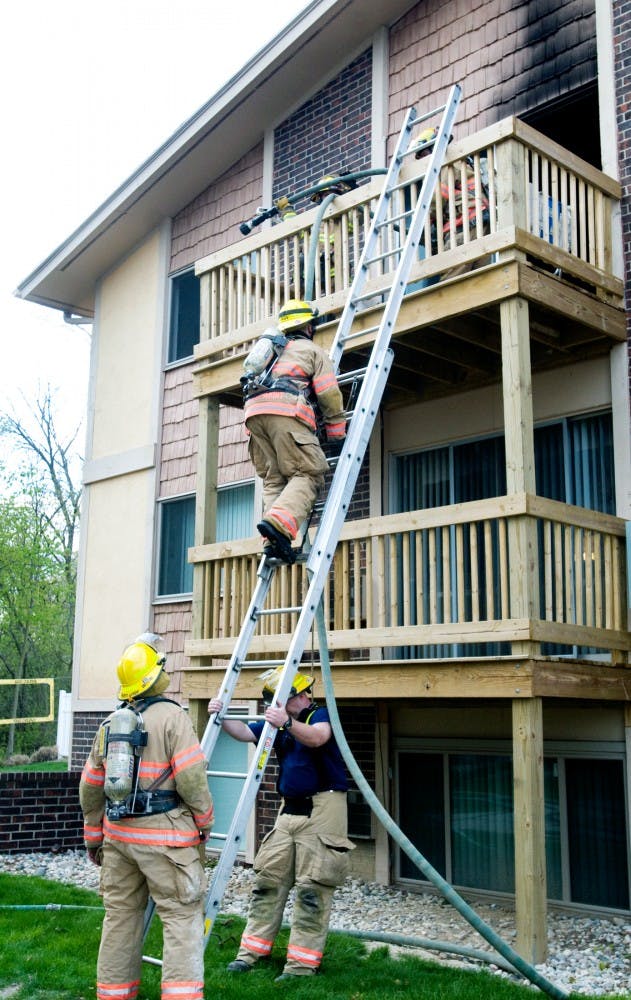 East Lansing firefighters remove a hose from an apartment that caught on fire Wednesday at 731 Burcham, East Lansing. The fire, which caused extensive smoke damage, started from the resident cooking on the stove. Jaclyn McNeal/The State News