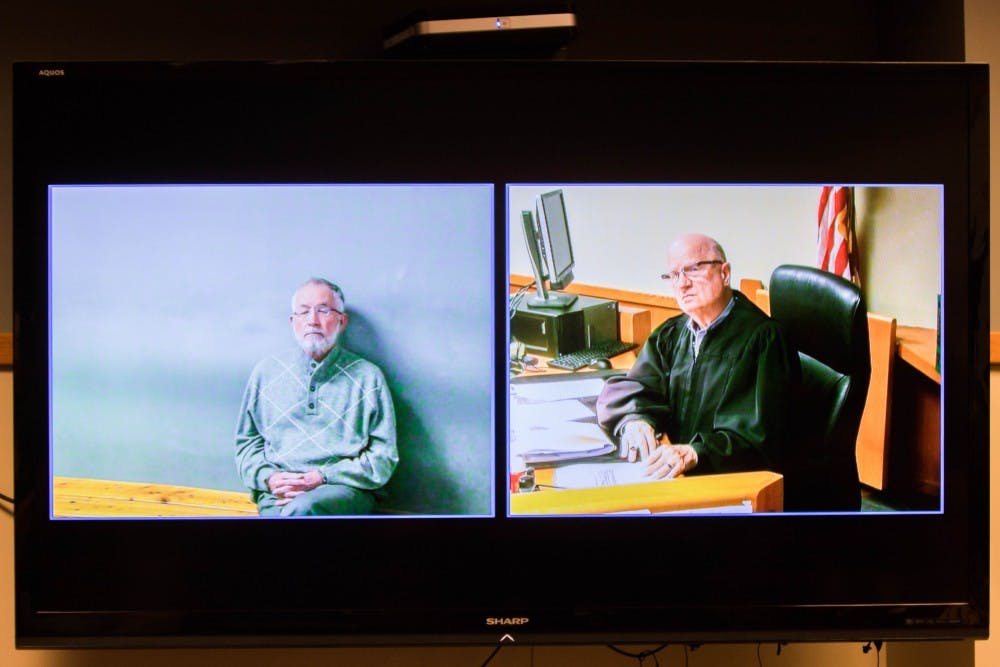 Former MSU dean William Strampel speaks with judge Richard D. Ball over video in the courtroom at the 54-B District Court on March 27. Strampel faces four charges, misconduct in office, a five-year felony, two counts of willful neglect of duty and one count of fourth-degree criminal sexual conduct.