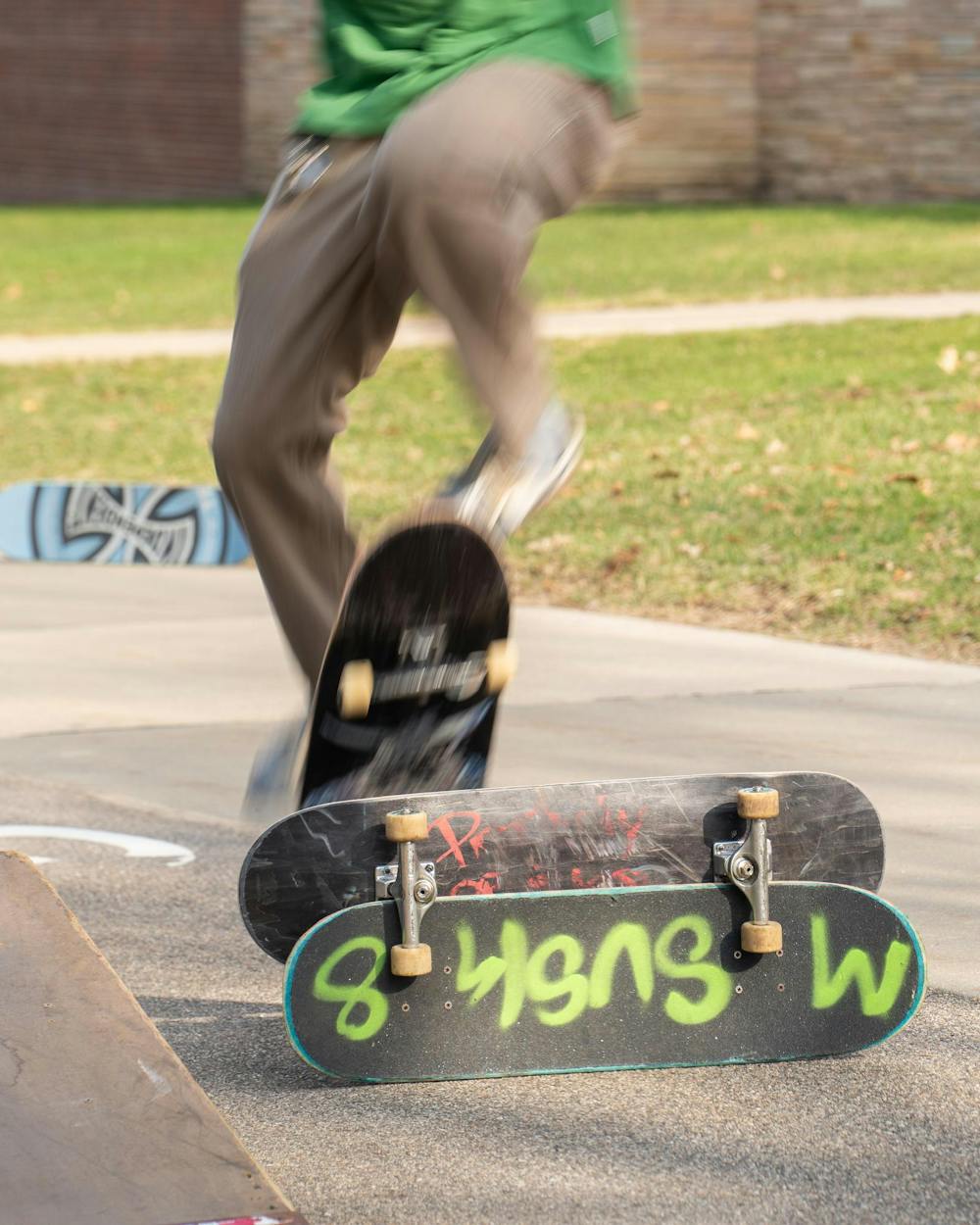 Bryson Taylor performs a trick over two skateboards during MSU Skate Club outside of Shaw Hall on Michigan State University’s campus in East Lansing, Mich., on March 20, 2026.