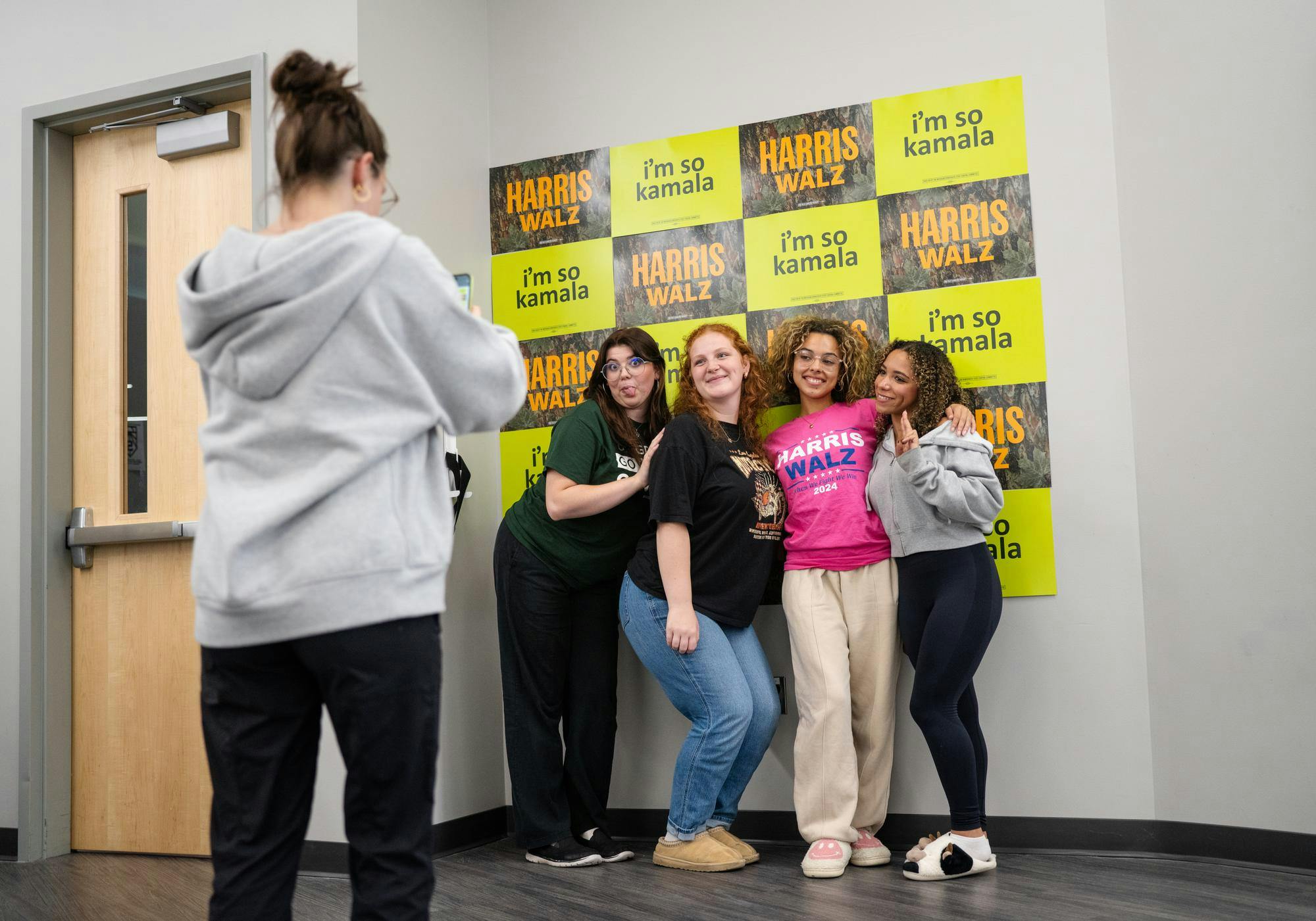 Michigan State University students pose for a picture in front of Kamala Harris themed signs at the College Democrats at MSU election watch party in Wonders Hall on Nov. 5, 2024. 