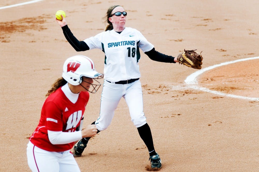 Freshman pitcher Cassee Layne throws the ball to first base after Wisconsin outfielder Kendall Grimm made a hit during Saturday's game at Secchia Stadium. It was the first game to be played at the stadium. Lauren Wood/The State News