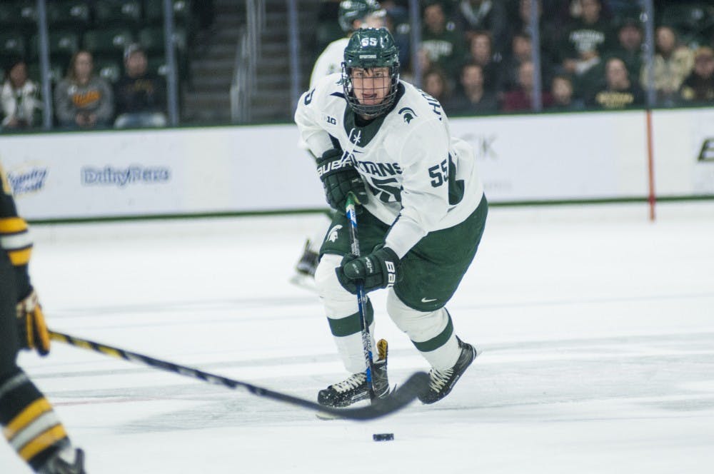 Freshman center Patrick Khodorenko (55) handles the puck in the game against Michigan Tech on Nov. 4, 2016 at Munn Ice Arena. The Spartans defeated the Huskies in overtime, 3-2.