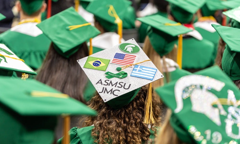 A James Madison College student wears a decorated cap during the Undergraduate Convocation Ceremony at the Breslin Student Events Center on May 3, 2019.