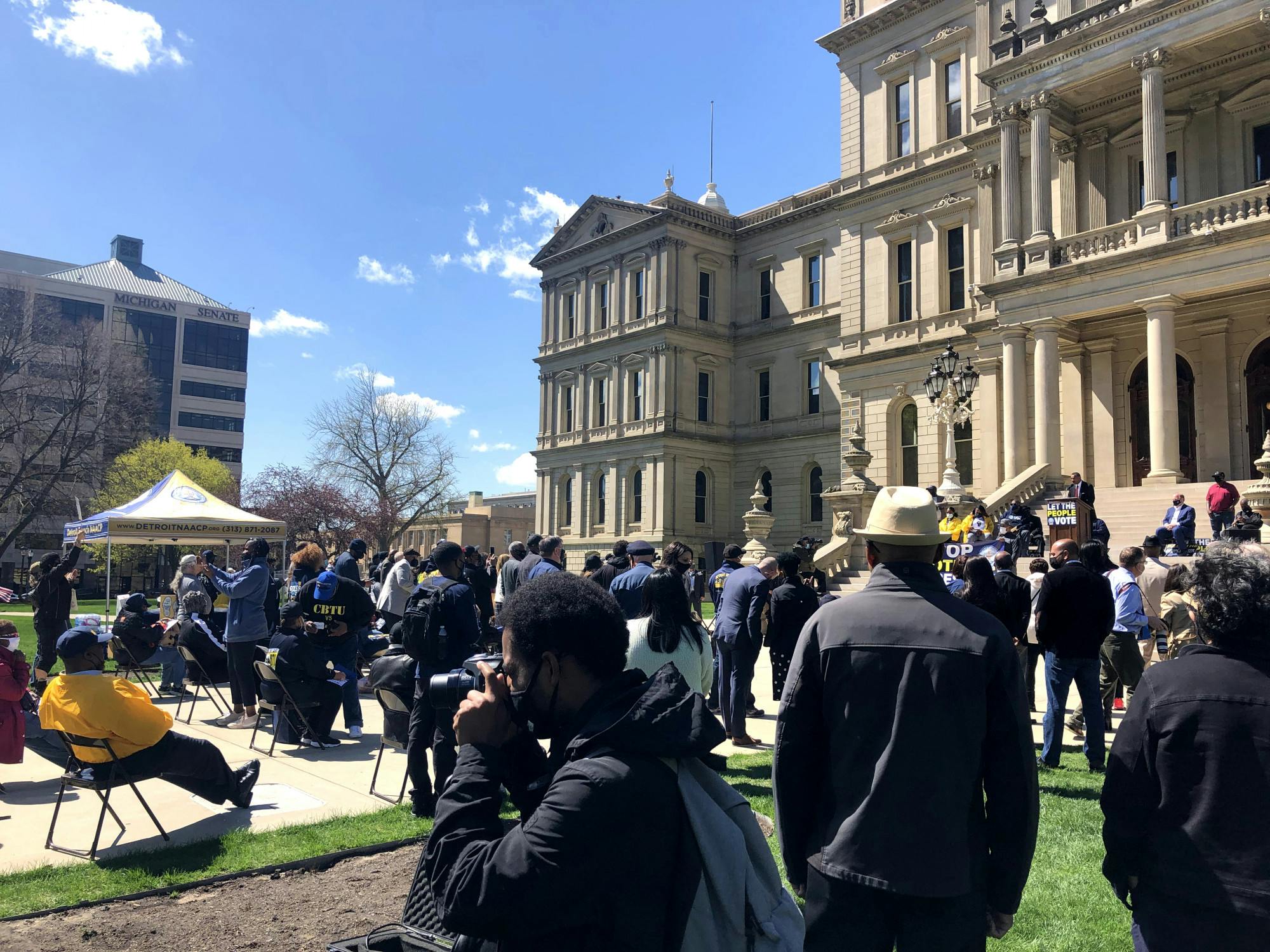 <p>On March 13, 2021, a crowd gathers at the Michigan Capitol building to rally and protest against a set of Republician-proposed voter laws that Democrats and other Michigan civil rights groups say would bring about voter suppression. </p>