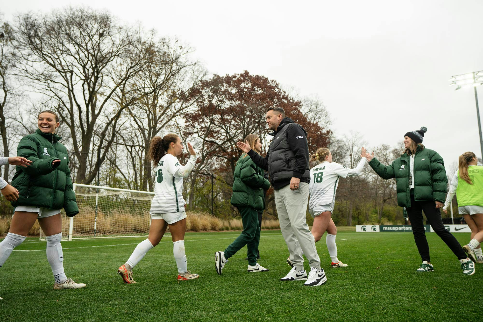 <p>Michigan State women’s soccer head coach Jeff Hosler and assistant coach Megan Link line up to high five the team after their win against Western Michigan at DeMartin Stadium on Nov. 16, 2024. Michigan State vs. Western Michigan was the first round of the NCAA D1 women’s soccer tournament, with the Spartans defeating the Broncos 3-1.</p>