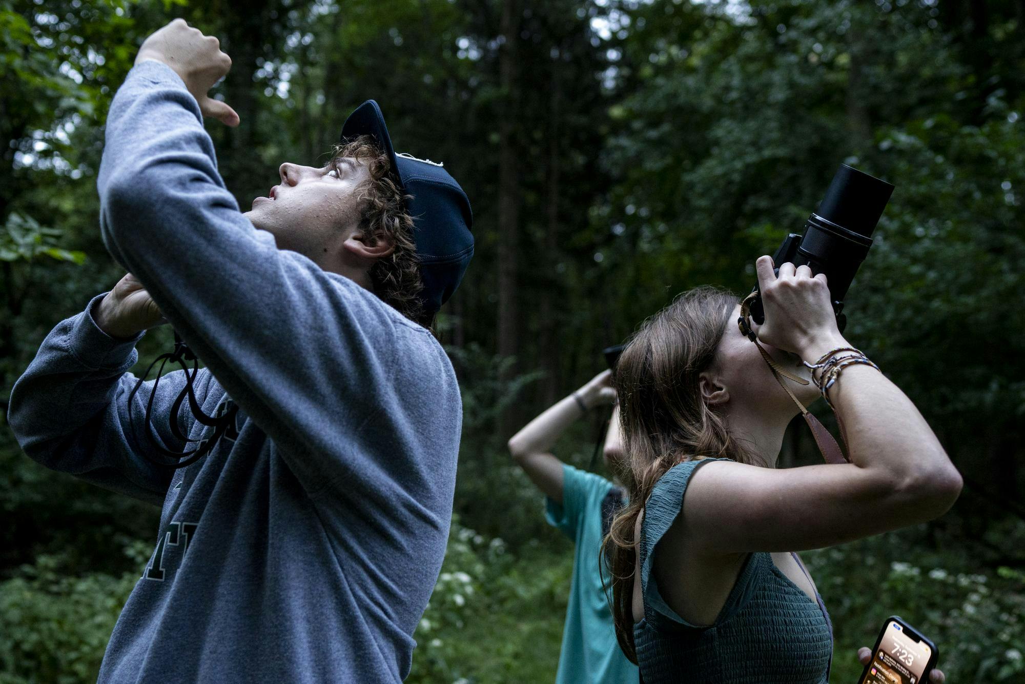 <p>Michigan State University neuroscience freshman Peter Moe and MSU Birding Club secretary Anneke Anglin look into the trees while searching for birds at Fenner Nature Center in Lansing, Mich., on Wednesday, Sept. 16, 2026.</p>