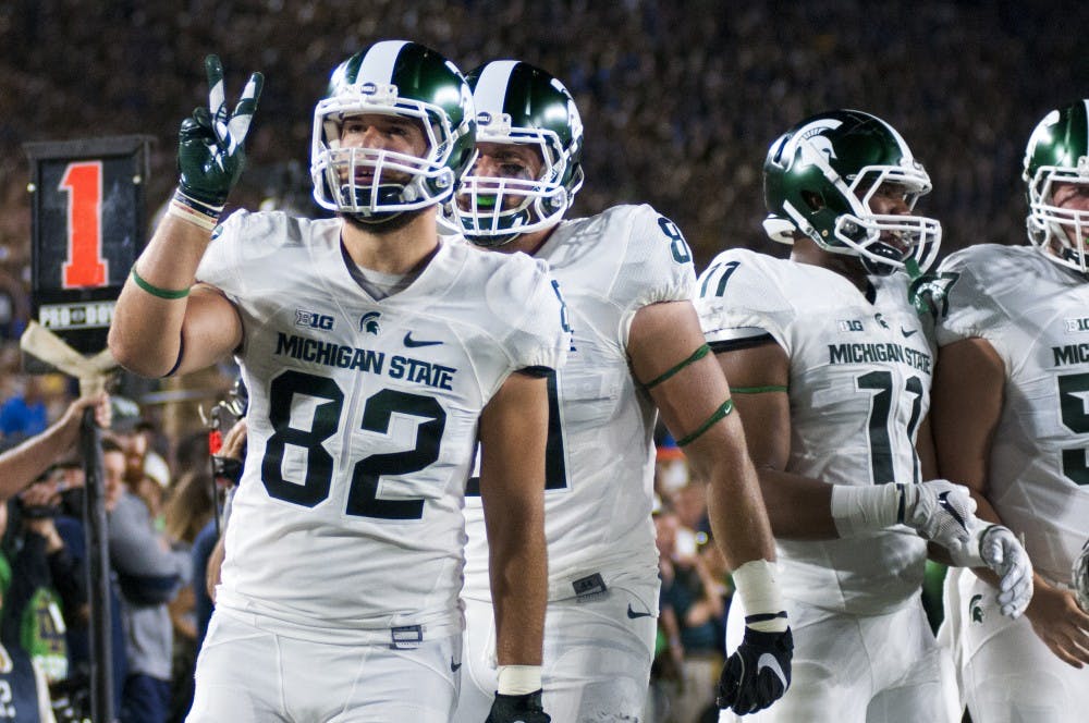 Senior tight end Josiah Price (82) holds up two fingers after a successful two point conversion during the game against Notre Dame on Sept. 17, 2016 at Notre Dame Stadium in South Bend, Ind.