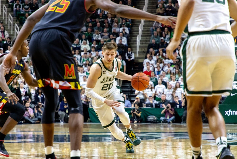 Senior guard Matt McQuaid (20) dribbles to the basket during the game against Maryland on Jan. 21, 2019. The Spartans lead the Terrapins 31-20 at halftime.