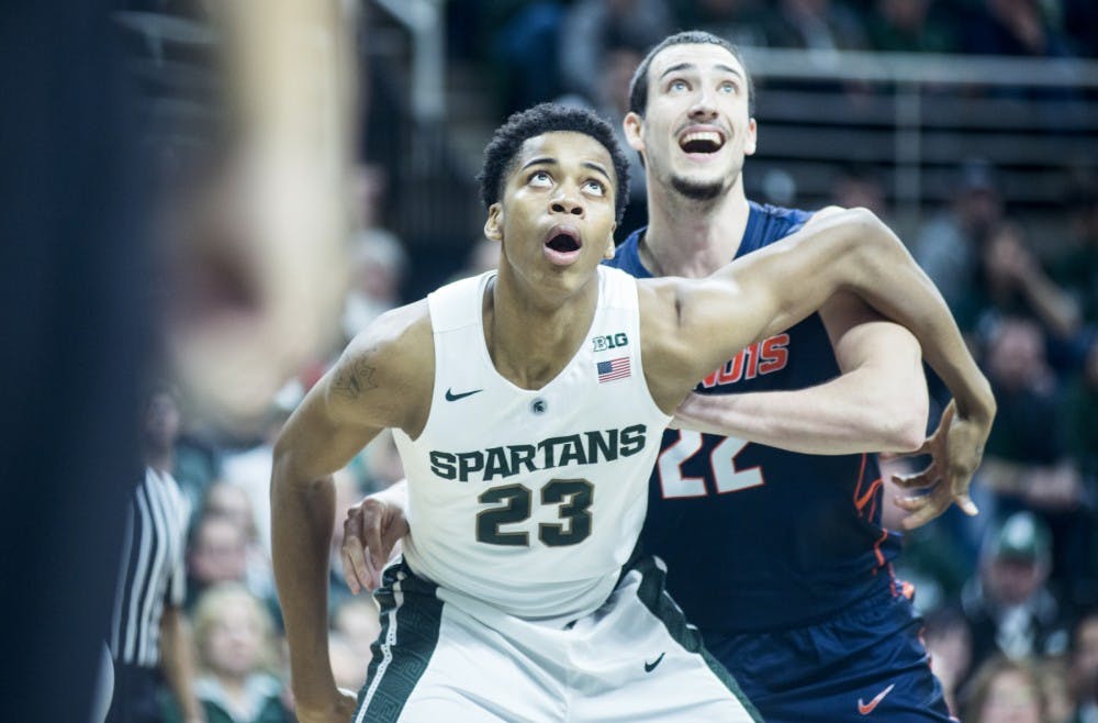Freshmen forward Deyonta Davis and Illinois center Maverick Morgan react to a shot during the second half of the game against Illinois on Jan. 7, 2016 at Breslin Center. The Spartans defeated the Illini 79-54.