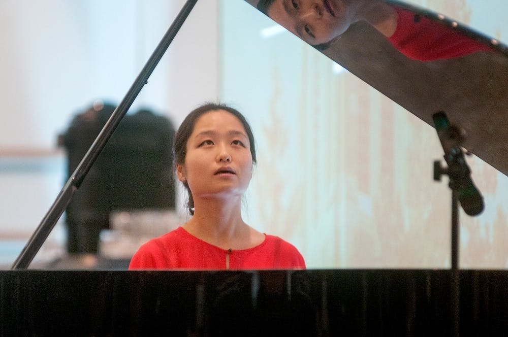 	<p>Music performance doctoral student Haobing Zhu performs a traditional Chinese piano piece after receiving an award during the Excellence in Diversity Recognitions and Awards program on Friday, Feb. 15, 2013 at the Kellogg Center. Zhu received the Students Making a Difference through Artistic Expression Award for the performance. </p>