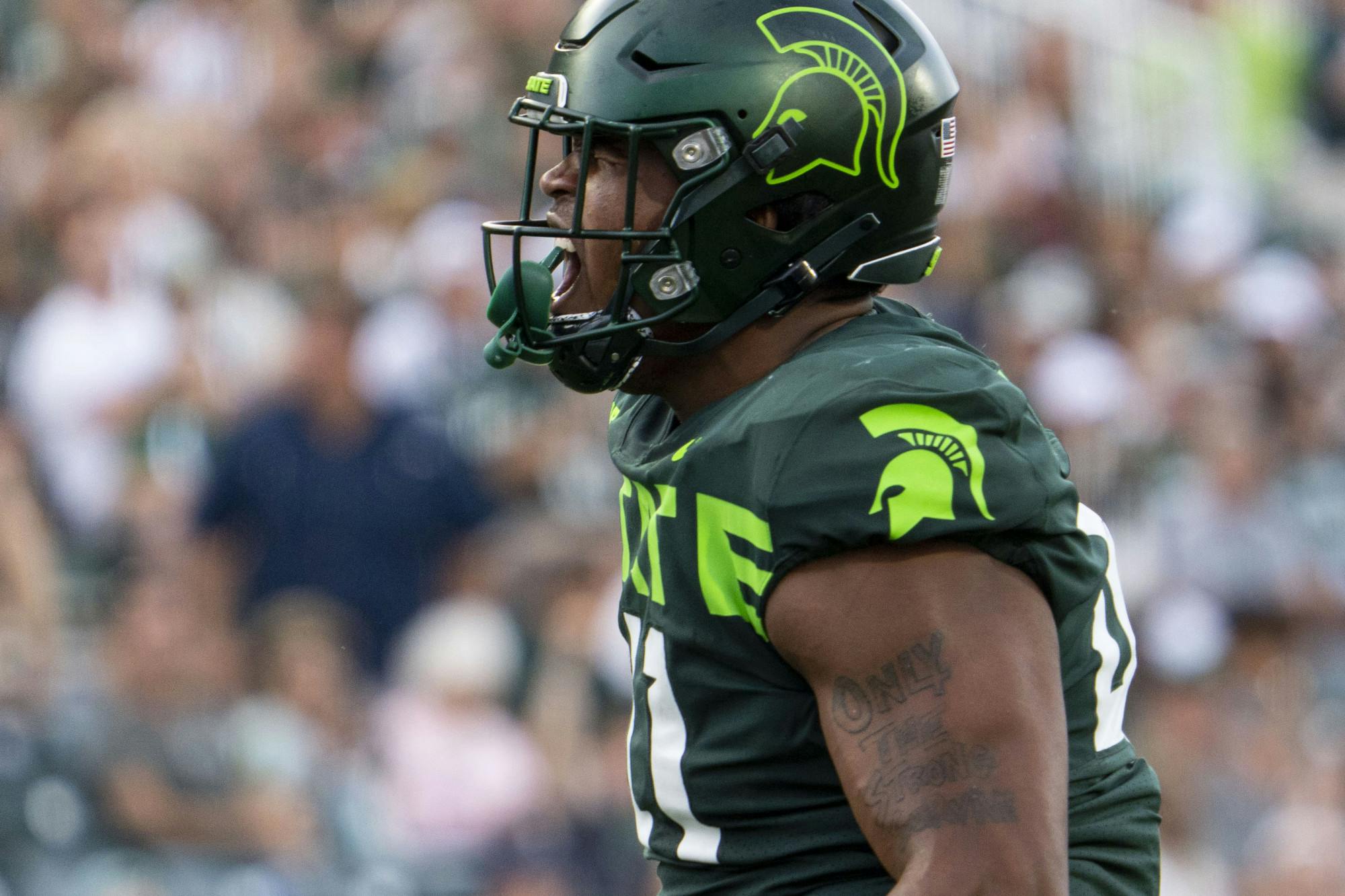 Senior linebacker Jacoby Windmon, 4, celebrates blocking a pass during Michigan State’s game against Akron on Sat., Sept. 10, 2022 at Spartan Stadium. The Spartans earned a decisive victory with a final score of 52, zip. 