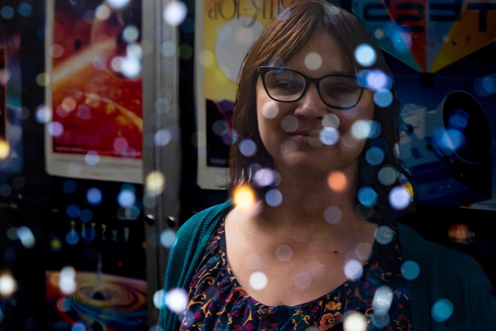Laura Chomiuk, professor in the Department of Physics and Astronomy, poses for a portrait while looking at an image of Hubble’s Deep Field on the wall of the observatory on the campus of Michigan State University in East Lansing, Mich., on Friday, Feb. 22, 2026.