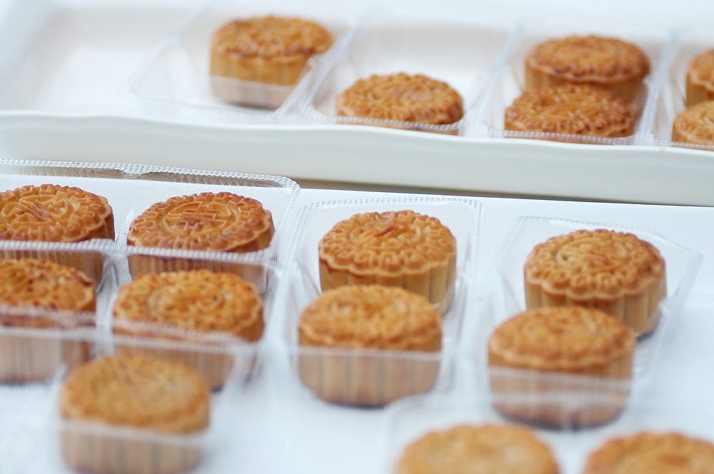 <p>Mooncakes rest on plates during a celebration of the Mid-Autumn Festival on Sept. 8, 2014, outside of The Eli and Edythe Broad Art Museum in East Lansing, Mich. Aerika Williams/The State News</p>