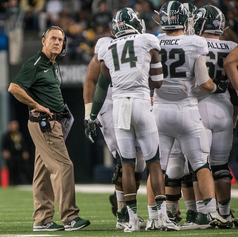 <p>Head coach Mark Dantonio looks up at the score board Jan. 1, 2015, during The Cotton Bowl Classic football game against Baylor at AT&T Stadium in Arlington, Texas. The Spartans defeated the Bears and claimed the Cotton Bowl Victory, 42-41. Erin Hampton/The State News</p>