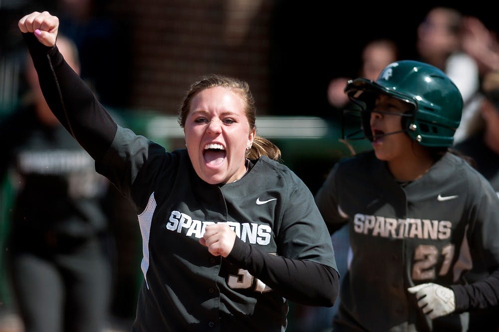 	<p>Junior catcher Emma Fernandez, left, celebrates as she runs towards the home plate after junior outfielder Sarah Bowling hit a home run in the bottom of the fourth inning, Saturday, March 30, 2013, at Secchia Stadium at Old College Field. <span class="caps">MSU</span> defeated Indiana in the second game of the three-game series by 10-7. Justin Wan/The State News</p>