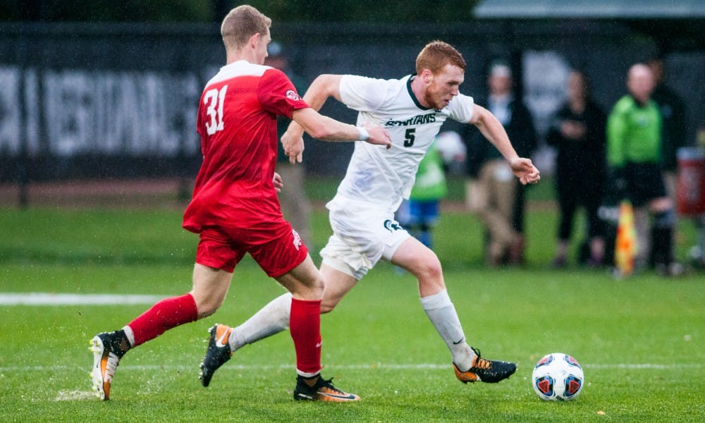 Sophomore defender Michael Pimlott (5) dribbles the ball upfield during the game against Ohio State, on Nov. 5, at DeMartin Stadium. The Spartans fell to the Buckeyes, 2-1, and were eliminated from the Big Ten tourney.