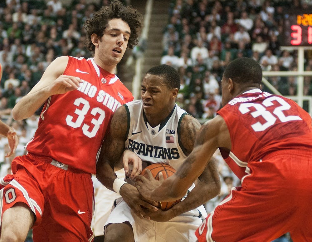 	<p>Senior guard Keith Appling tries to keep the ball from Ohio State guards Amedeo Della Valle, 33, and Lenzelle Smith Jr., 32, on Jan. 7, 2014, at Breslin Center. The Spartans defeated the Buckeyes in overtime, 72-68. Danyelle Morrow/The State News</p>