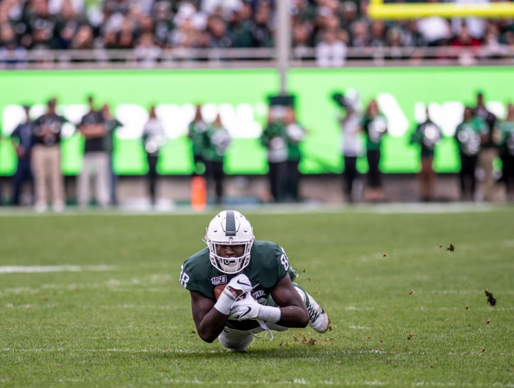 <p>Then-redshirt freshman Trenton Gillison (88) dives with the ball during the first quarter of the homecoming game against Indiana on Sept. 28, 2019, at Spartan Stadium. The Spartans led the Hoosiers 21-14 at halftime.</p>