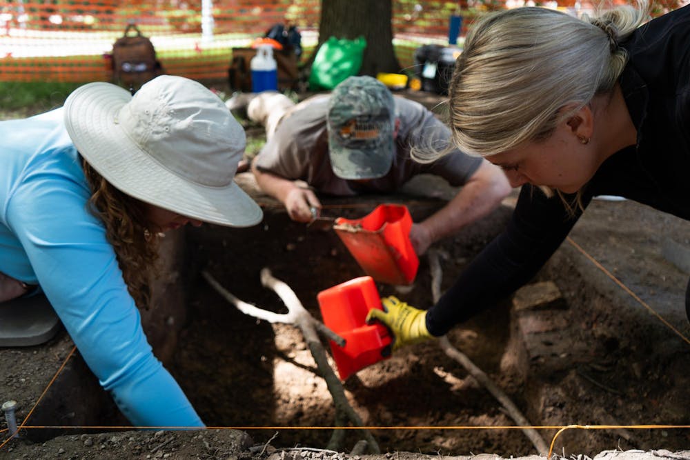 <p>Anthropology PhD students Madelyn McKinney, Andrew Kracinski and Gabrielle Moran-O'Dell (left to right) work on excavating the old observatory site in East Lansing, Mich., on June 15, 2026.</p>