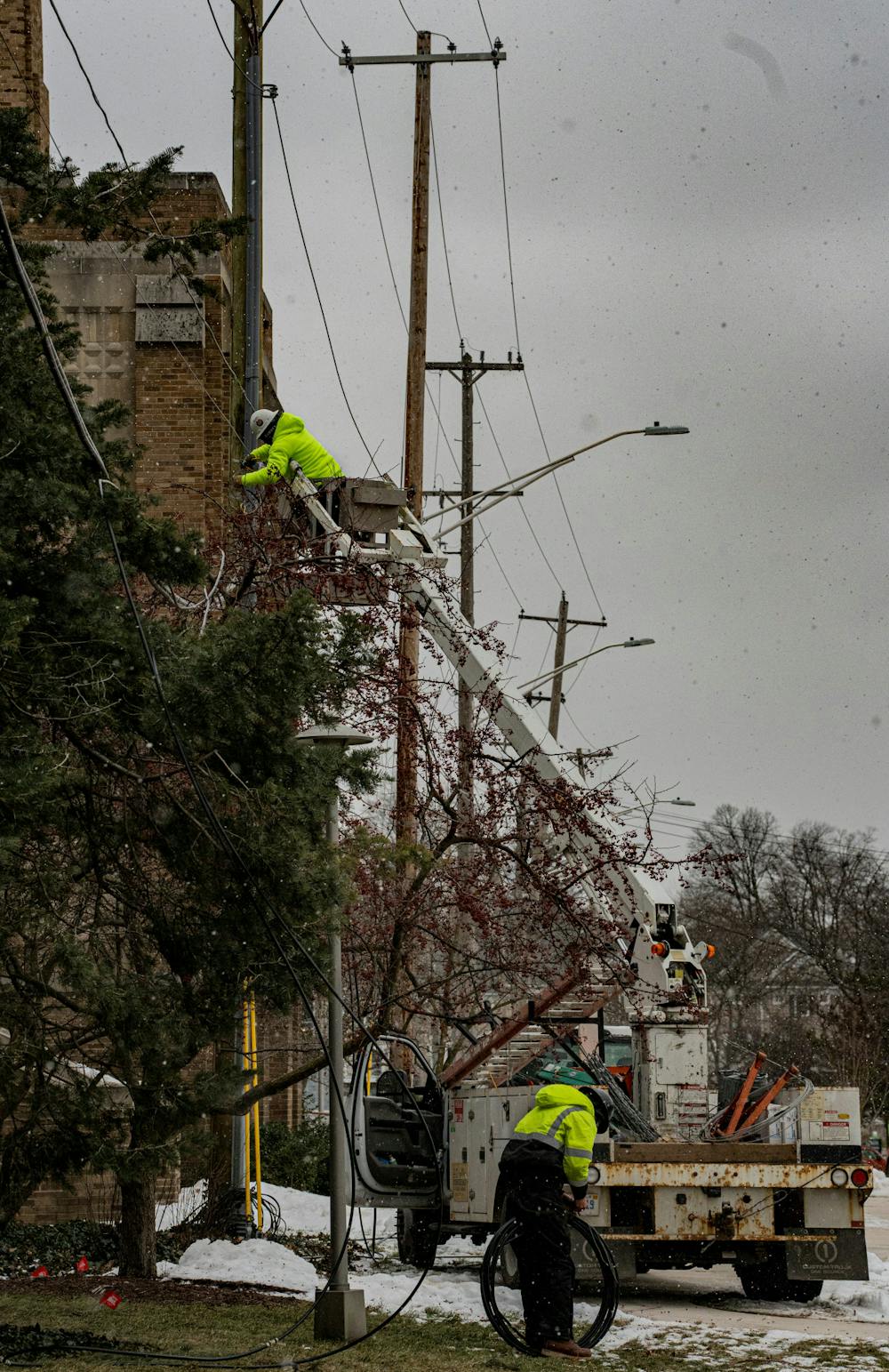 A worker fixing the power lines in front of the People's Church located across the street from the under construction MSU Federal Credit Union branch site. Shot Jan. 19, 2022