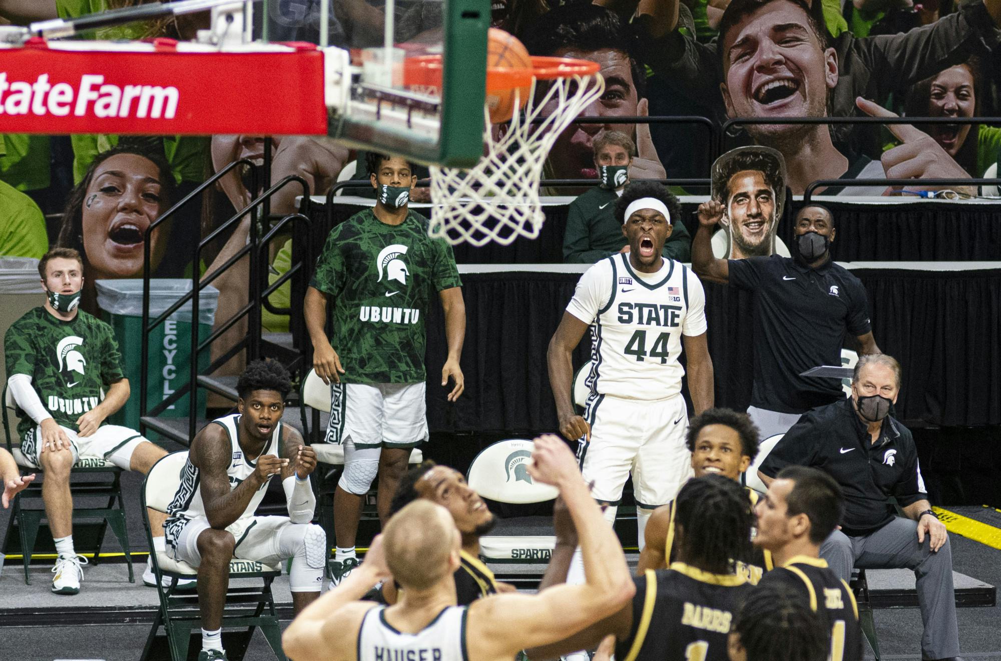 Junior forward Gabe Brown (44) and his Spartan teammates anticipate a three-pointer from Aaron Henry and start cheering in the second half of the game. The Spartans came back in the second half to end the game against the Broncos 79-61 on Dec. 6, 2020.