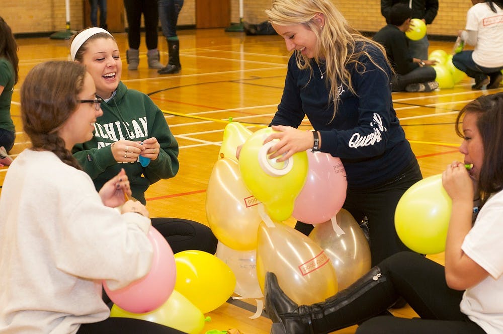 	<p>From left, pre-medical freshman Jaqui Somes, no preference freshman Allison Sirosky, supply chain management freshman Jamie Ulanch and communications junior Michelle Francis build a balloon tower Nov. 15, 2013, at IM Sports Circle. Students stayed up all night playing games, watching videos and eating to celebrate their fundraising for St. Judes research hospital.</p>