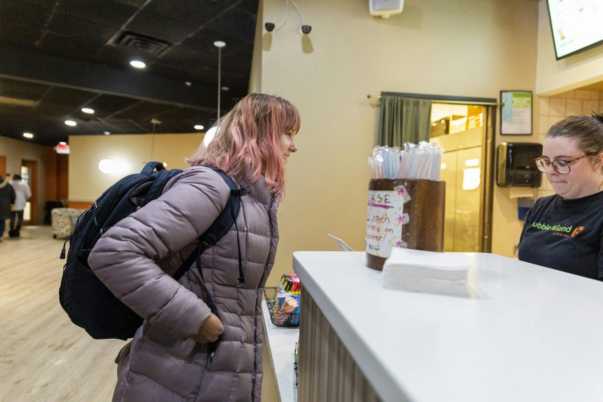 <p>East Lansing High School sophomore Katherine Hawthorne pays for her last bubble tea on Nov. 14, 2019. The East Lansing Bubble Tea Island location is set to close on Nov. 16. </p>