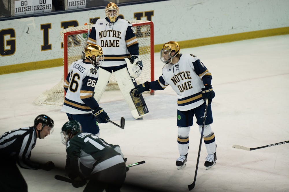 <p>Notre Dame defensemen Zach Plucinski and Jake Boltmann exchange a few words before face-off at Compton Family Ice Arena in Notre Dame, IN on Friday, March 4, 2023. Plucinski and Boltmann together blocked a total of 10 shots in the Saturday night contest at home.</p>