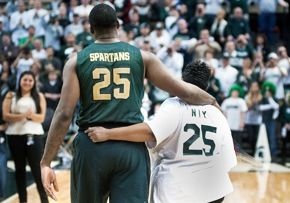 	<p>Senior center Derrick Nix walks with his mother Darlis Nix on Senior Night after the game against Northwestern on March 10, 2013, at Breslin Center. Nix scored 10 points in the game. Katie Stiefel/The State News</p>