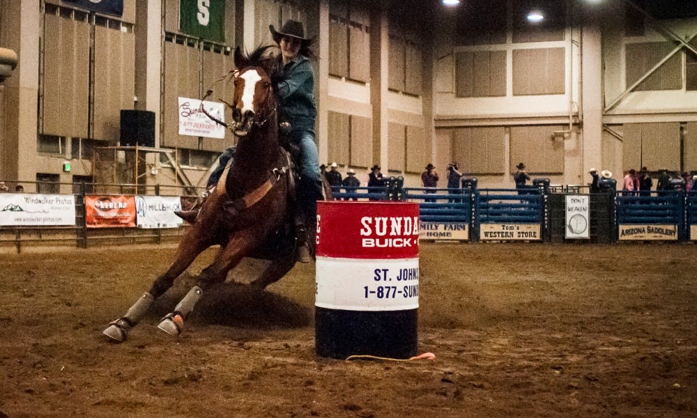 Mcbain, Mich. resident Jessica Lauterwasser circles the last barrel as she competes in barrel racing on Feb.18, 2017 at the MSU Pavilion for Agriculture and Livestock Education. The rodeo showcased premier athletes from the ranks of the International Professional Rodeo Association and MSU Rodeo Club.