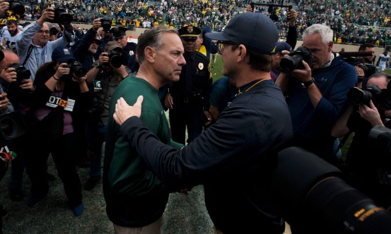 Head coach Mark Dantonio and Jim Harbaugh shake hands after the game against Michigan on Oct. 29, 2016 at Spartan Stadium. The Spartans were defeated by the Wolverines, 32-23.