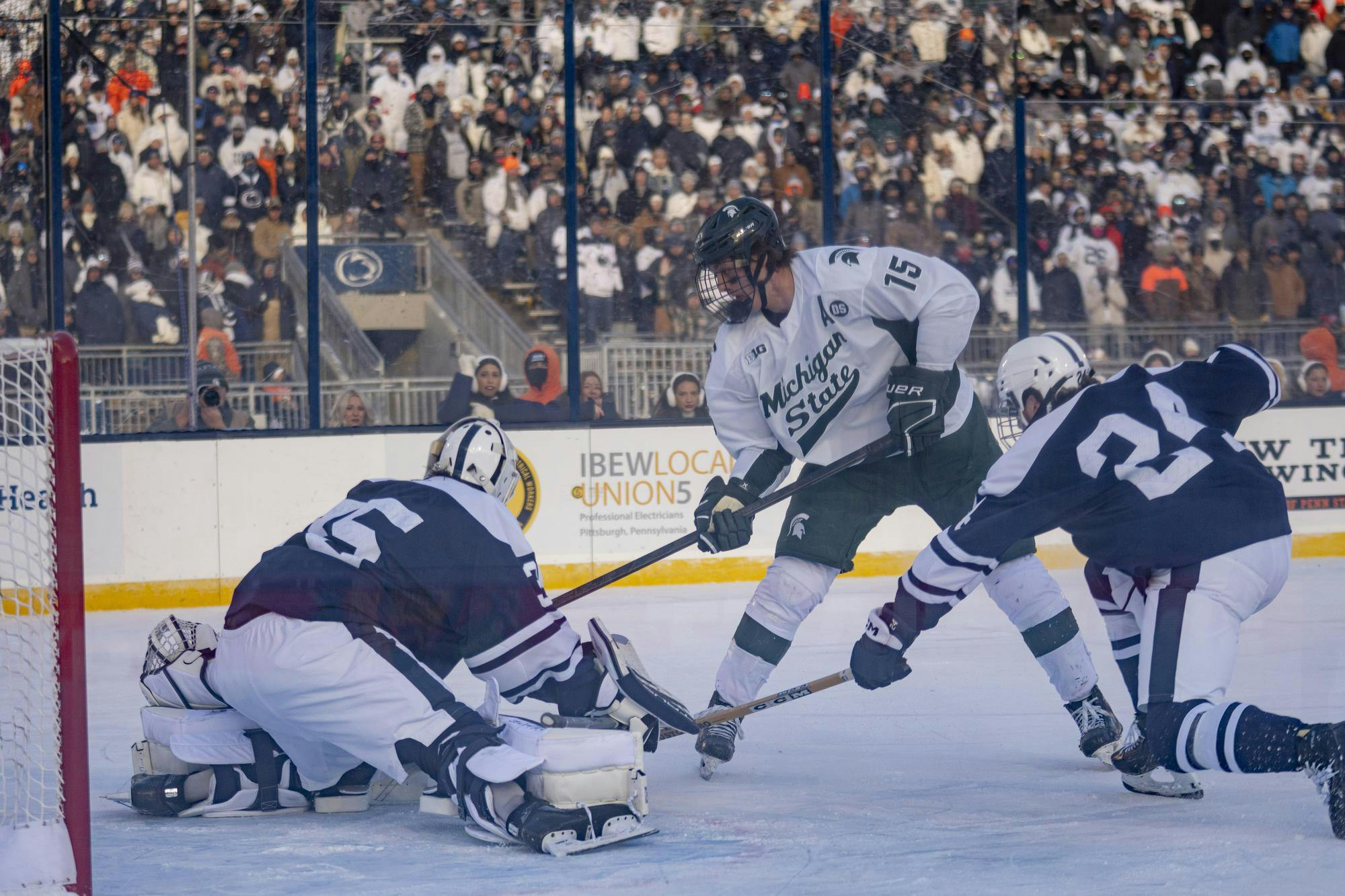 <p>Michigan State senior forward Charlie Stramel (15) scores game-winning goal against Penn State goaltender Kevin Reidler (35) during a game between Michigan State and Penn State at Beaver Stadium in University Park, Pennsylvania, on Saturday, Jan. 31 2026.</p>