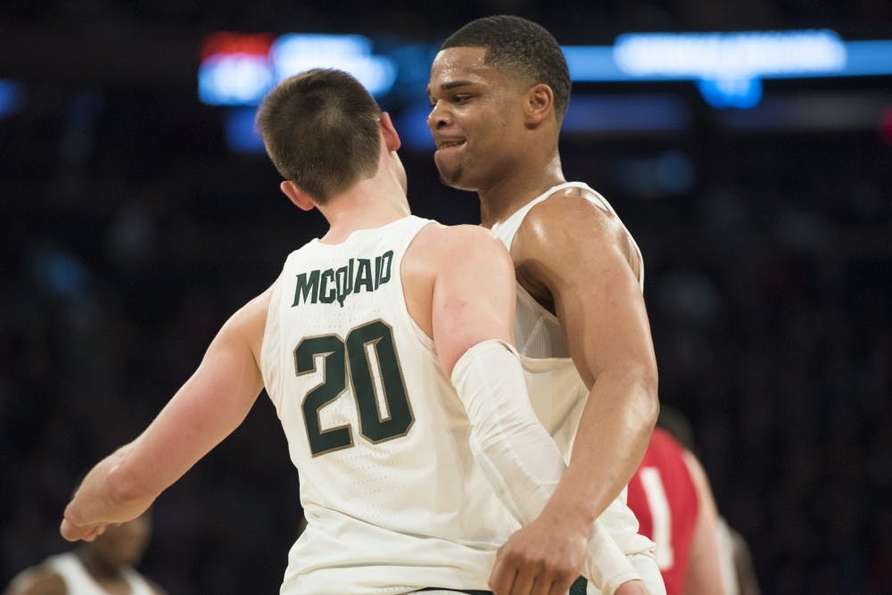 Sophomore guard Miles Bridges (22) chest bumps junior guard Matt McQuaid (20) after McQuaid scored a 3-pointer during the second half of the 2018 Big Ten Men's Basketball quarterfinal game against Wisconsin on March 2, 2018 at Madison Square Garden in New York. (Nic Antaya | The State News)