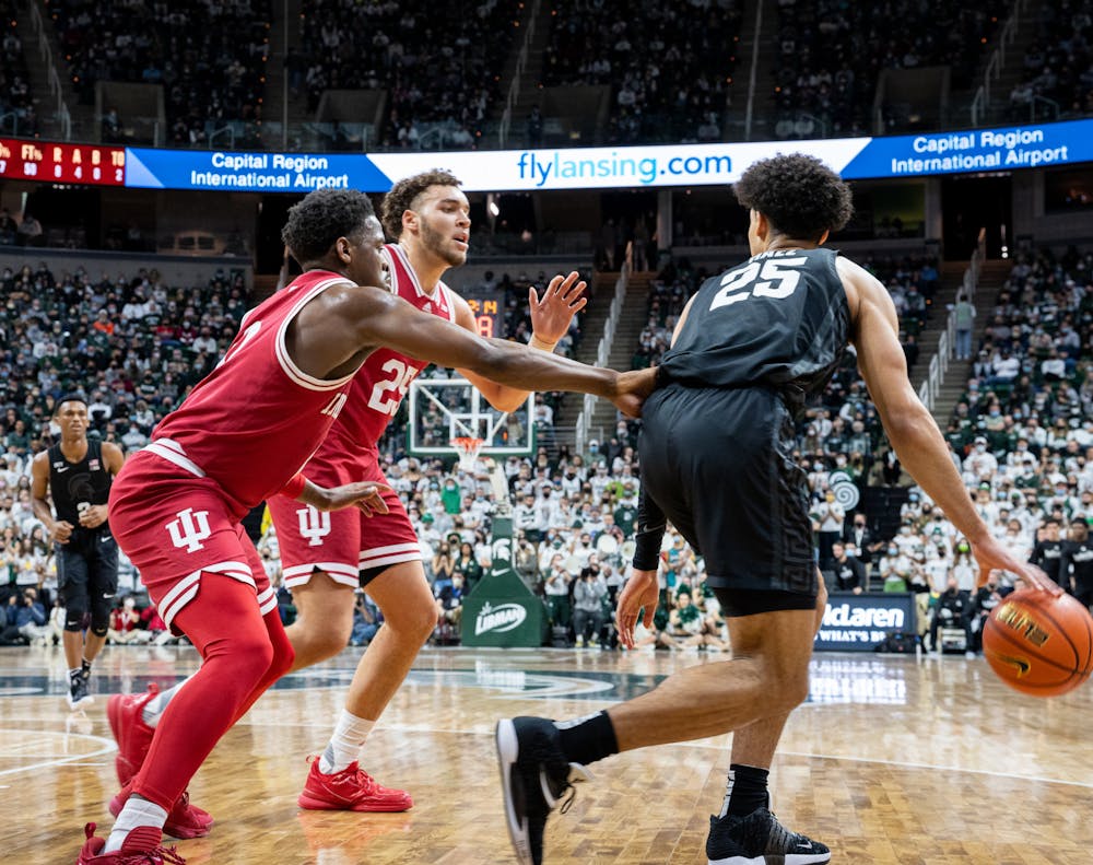 <p>Michigan State junior forward Malik Hall (25) protects the ball from Indiana&#x27;s senior guard Xavier Johnson (0) and redshirt senior forward Race Thompson (25) during Michigan State&#x27;s victory over Indiana on Feb. 12, 2022.</p>