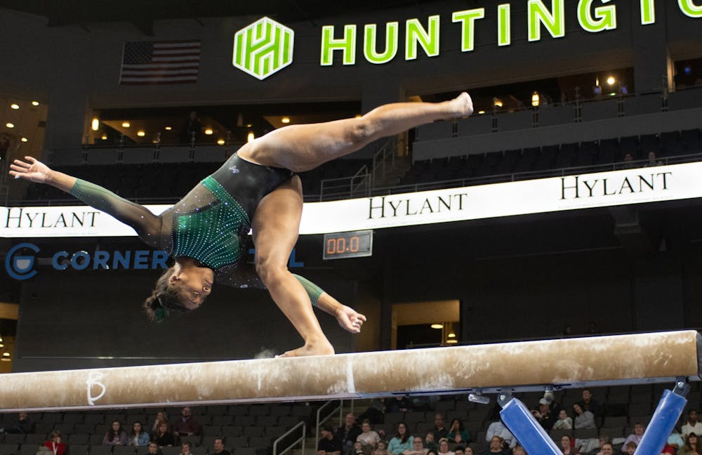 <p>Sophomore Alaina Raybon finishes her flip on Feb. 22, 2020 during Elevate the Stage at the Huntington Center in Toledo, Ohio. </p>