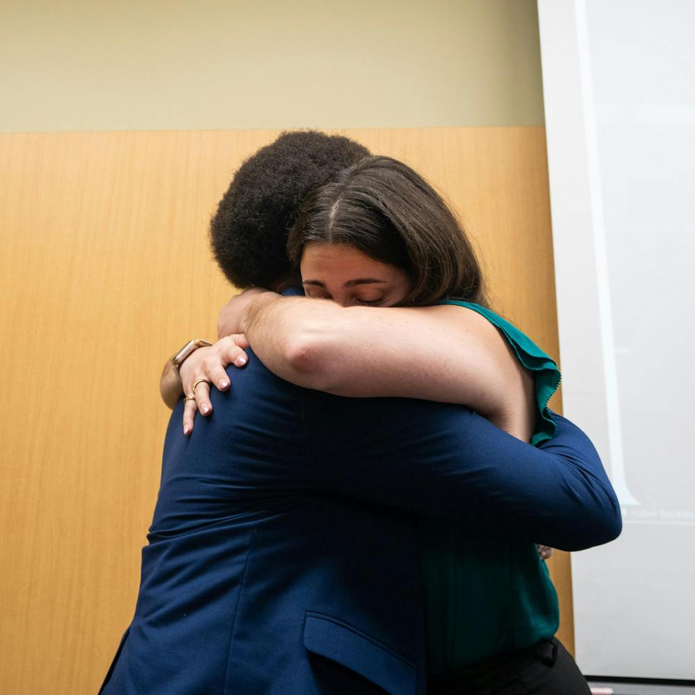 ASMSU future President, Maddie Hanes and current Vice President for Governmental Affairs, Deonte Sparks embrace each other after racing against each other for ASMSU president in the Student Affairs & Services building in East Lansing, MI on April 14, 2026.